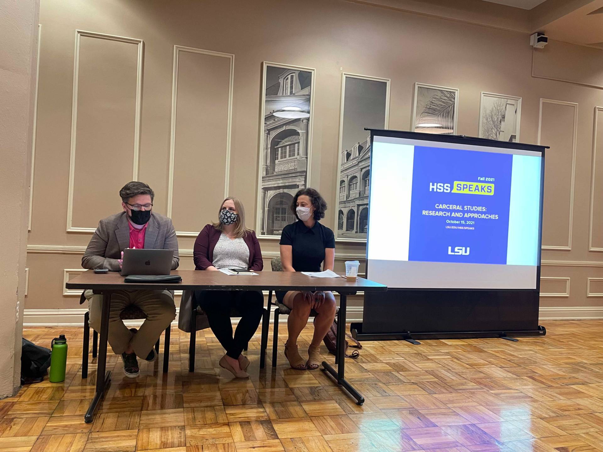 Three professors sitting at a table