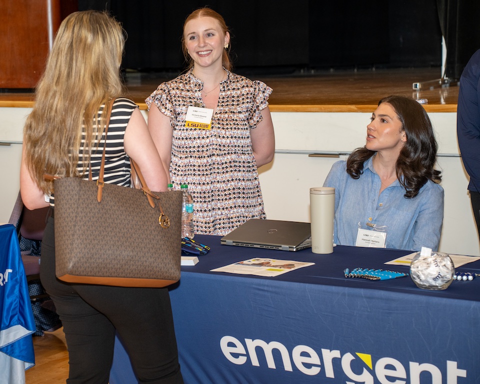 Employers speaking with student at table sit